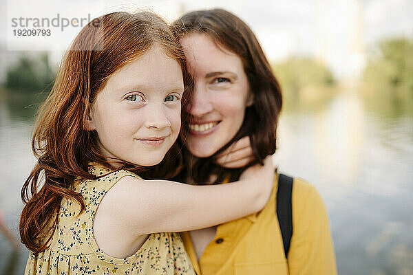 Happy daughter embracing mother in park