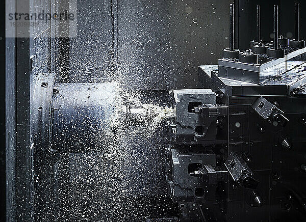 Automatic CNC machine cutting metal in factory