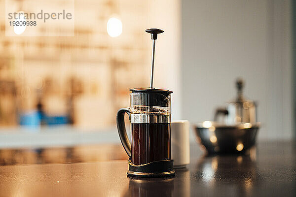 French press coffee maker on table at home