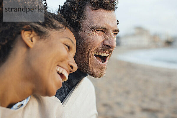 Couple laughing together at beach