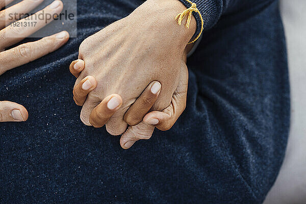 Loving couple holding hands together