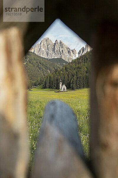 Church view in front of mountains and pine forest