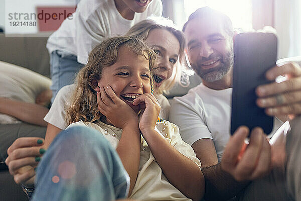 Glückliche Familie  die zu Hause ein Selfie mit dem Smartphone macht