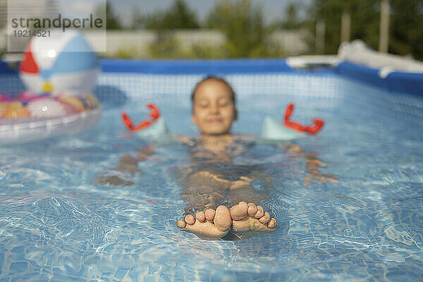 Girl spending leisure time in swimming pool