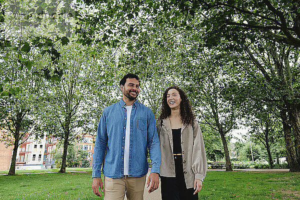 Happy couple walking in park
