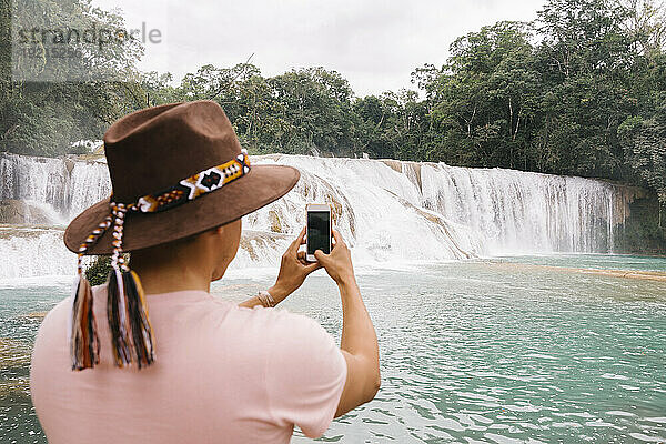 Mann fotografiert Agua Azul Cascades mit Smartphone