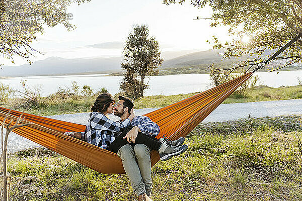 Affectionate couple relaxing in hammock