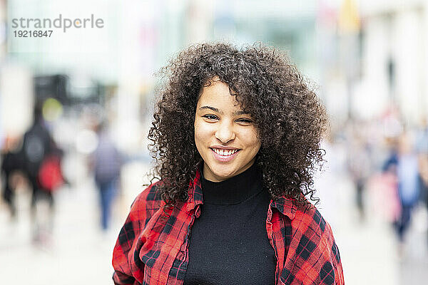 Smiling young woman with curly hair
