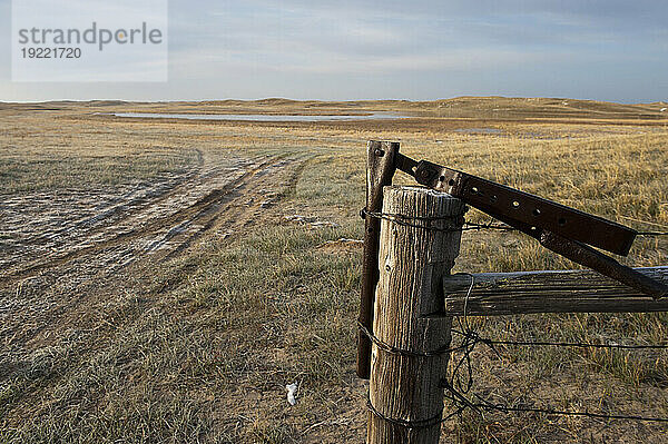 Fence  post and gate latch in the countryside of the Nebraska Sandhills  USA; Sandhills  Nebraska  United States of America