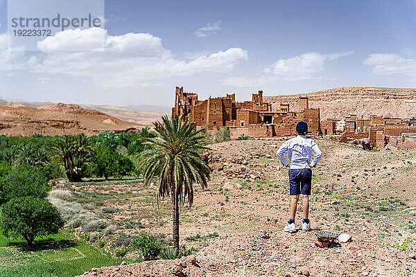 Rückansicht eines Jungen  der eine alte Kasbah bewundert  Ounila-Tal  Atlasgebirge  Provinz Ouarzazate  Marokko  Nordafrika  Afrika