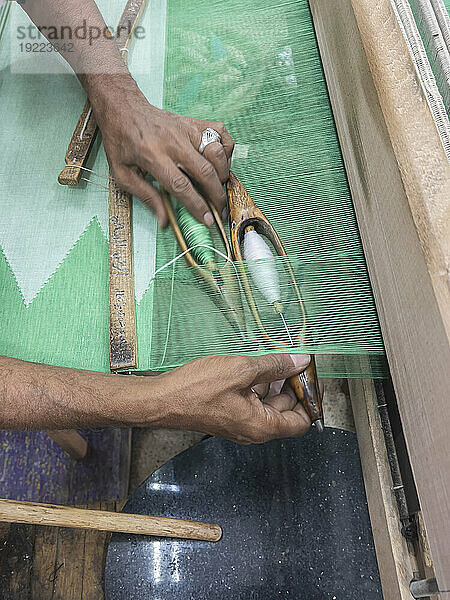 Egyptian man working on a loom in a shop at the unfinished obelisk in Aswan  Egypt  North Africa  Africa
