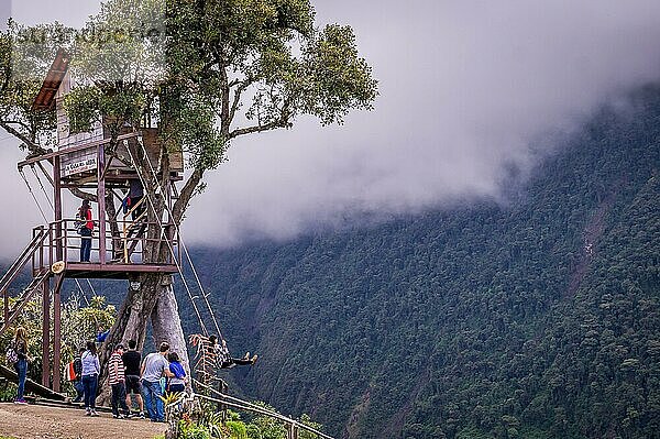 Banos  Ecuador am 18. November 2015: Touristen genießen die Riesenschaukel im Baumhaus Casa del Arbol in den Anden bei Banos  Ecuador. Die Aussicht von der Schaukel ist atemberaubend