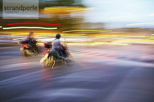 Abstraktes  unscharfes Bild eines nachts fahrenden Mopeds