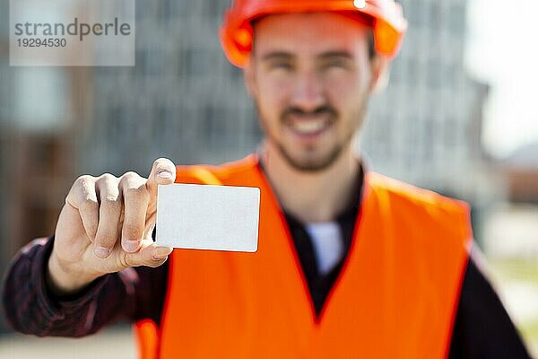 Porträt eines Bauingenieurs mit Visitenkarte in der Hand