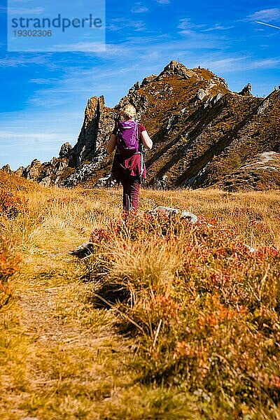 Wanders Frau auf Weg zum Gipfelkreuz in felsiger Gebiergslandschaft im Herbst  Hirschkarspitze  Alpen  Österreich  Europa