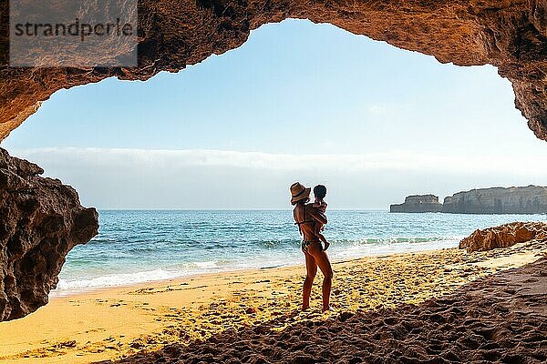 Mit dem Sohn in der natürlichen Strandhöhle an der Algarve am Praia da Coelha  Albufeira. Portugal