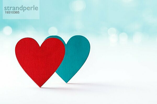 Rote und blaue Herzen aus Holz auf weißem Hintergrund mit Bokeh Lichter  Valentinstag Konzept