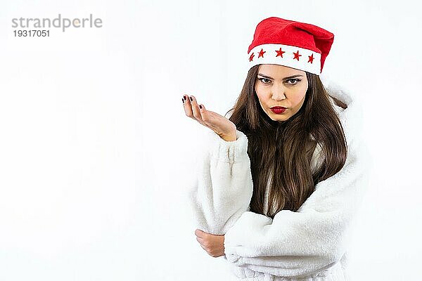 Brünettes lateinamerikanisches Mädchen an Weihnachten mit weißem Hintergrund  mit einer Weihnachtsmütze mit Sternen  Porträt mit Blick in die Kamera  Kopierraum