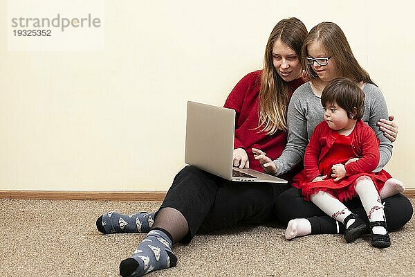 Frontansicht Frau Kinder mit Down Syndrom schauen Laptop