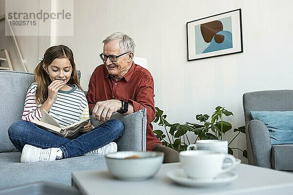 Großvater und Mädchen lesen zusammen