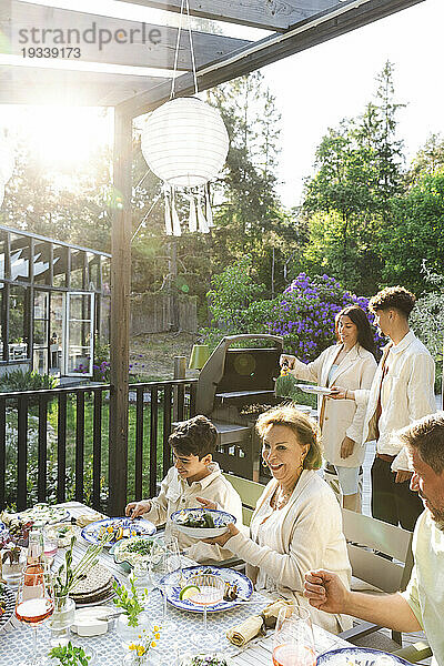 Familie genießt Sommerdinnerparty im Hinterhof