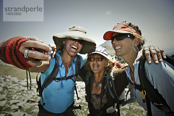Drei Frauen posieren für ein Selbstporträt beim Wandern im Freien  La Sal Mountains  Utah.
