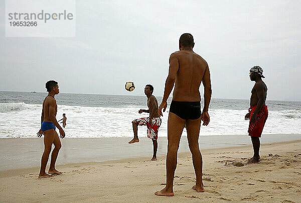 Männer spielen Fußball am Strand der Copacabana  Rio de Janeiro  Brasilien.