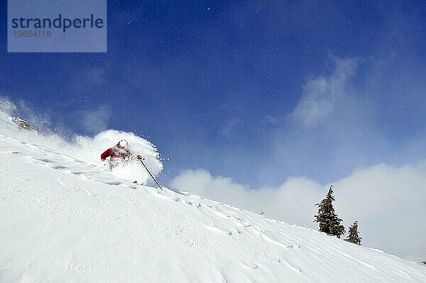 Ein Mann beim Skifahren an einem Bluebird-Powder-Tag in einem Bergresort in der Nähe von South Lake Tahoe  Kalifornien.