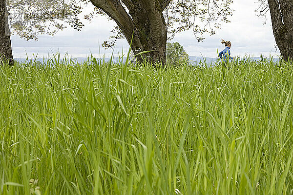 Eine Frau rennt durch ein Grasfeld