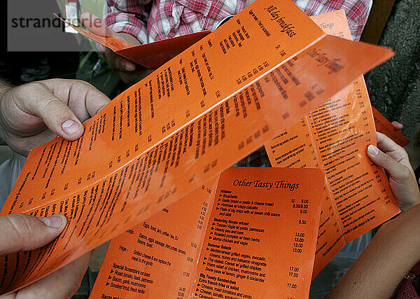 Tourists reading the menu while waiting for seats at a restaurant  Cuzco  Peru.