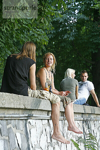 Menschen sitzen in einem Park auf der Slovansky Ostrov (Slaweninsel)  Nove Mesto  Prag  Tschechische Republik.