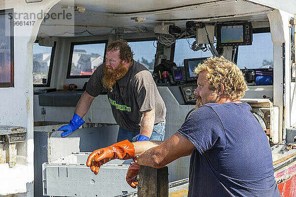 Kapitän Richard Smith („Bad Behavior“) und Hafenarbeiter Gary Emerson (links) am Kai von Great Wass Lobster in Beals  Maine.