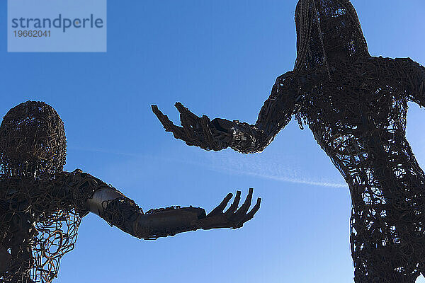 Metallskulptur von zwei Personen.