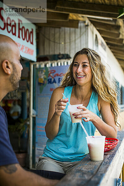 Eine schöne Frau genießt eine Pina Colada in einer Kneipe in Puerto Rico.