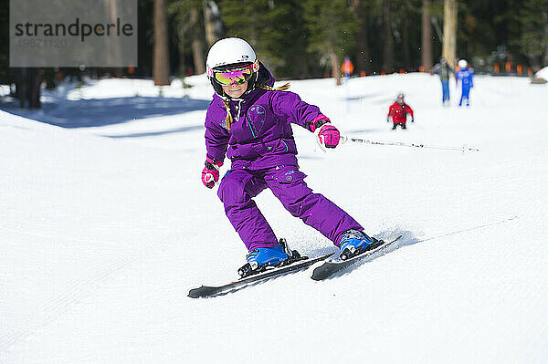 A young skier carves a turn on a groomed run at Kirkwood Mountain Resort in Kirkwood  California.