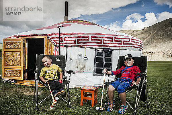 Junge mongolische Nomadenjungen sitzen vor dem Ger-Zelt (Jurte)  Bunkhan  Bulgan  Mongolei