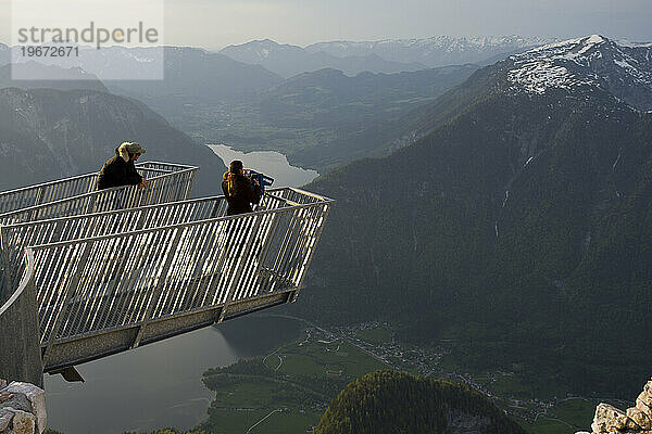 Besucher des 5-Finger-Aussichtspunkts am Krippenstein blicken hinunter auf Hallstatt und Obertraun  Österreich.