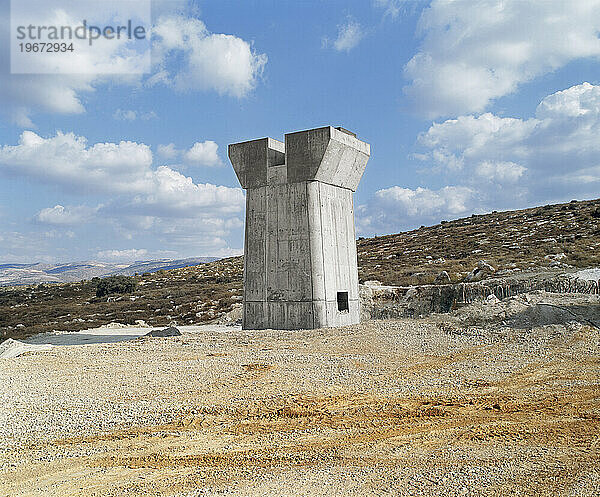 Im Bau befindliche Brücke  Pfeiler und Hochstraße durch eine trockene Landschaft.