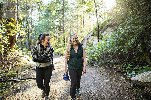 Freunde  Mütter wandern  laufen Kilometer und lachen gemeinsam auf dem Wanderweg