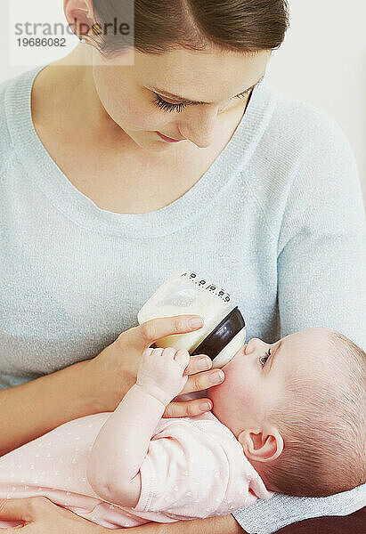 Mutter füttert ihr Baby mit der Flasche