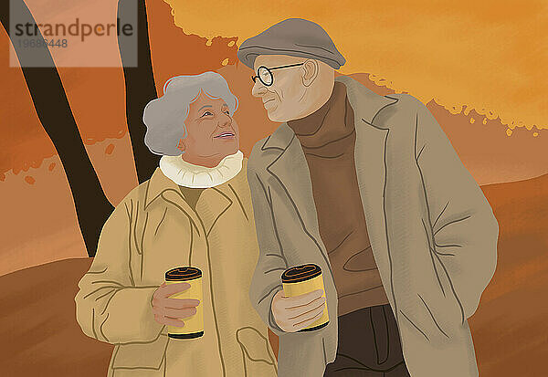 Glückliches älteres Paar  das mit Kaffee im Herbstpark spaziert