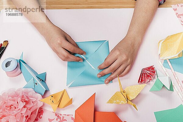 Ansicht von oben Frau Hand machen Origami Handwerk Tisch