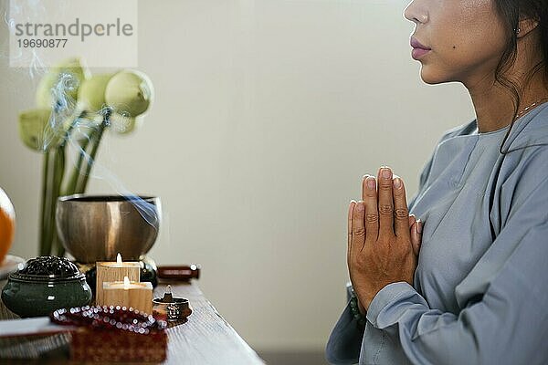 Seitenansicht Frau betet vor Kerzen
