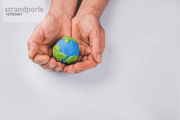 Hände Kind hält bunten Ton Modell Planet Erde