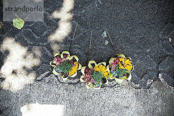 Drei schöne bunte Opernschalen am Straßenrand. Blumen als Opfergabe in Ubud  Bali
