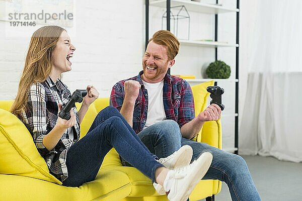Porträt aufgeregtes junges Paar genießt spielen Videospiel zu Hause