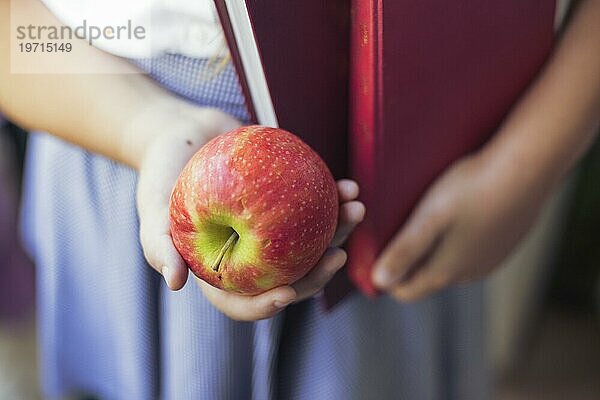 Mädchen Uniform mit Apfel Bücher Hände
