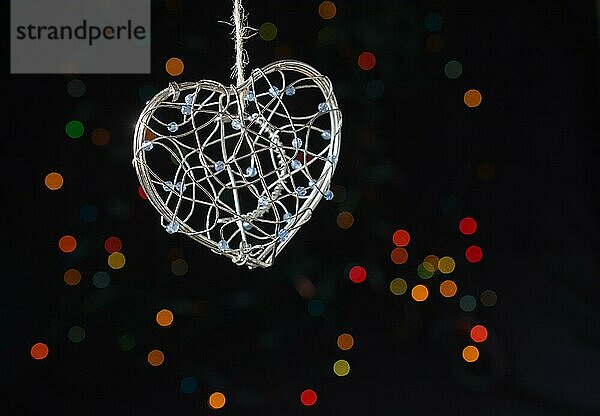 Herzförmige Metallkäfig auf einem Bokeh Licht Hintergrund