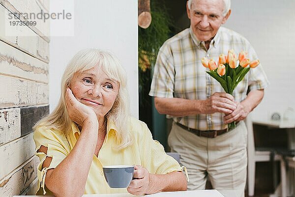 Älterer Mann  stehend  geliebt mit Blumen