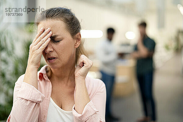 Female office worker having a headache